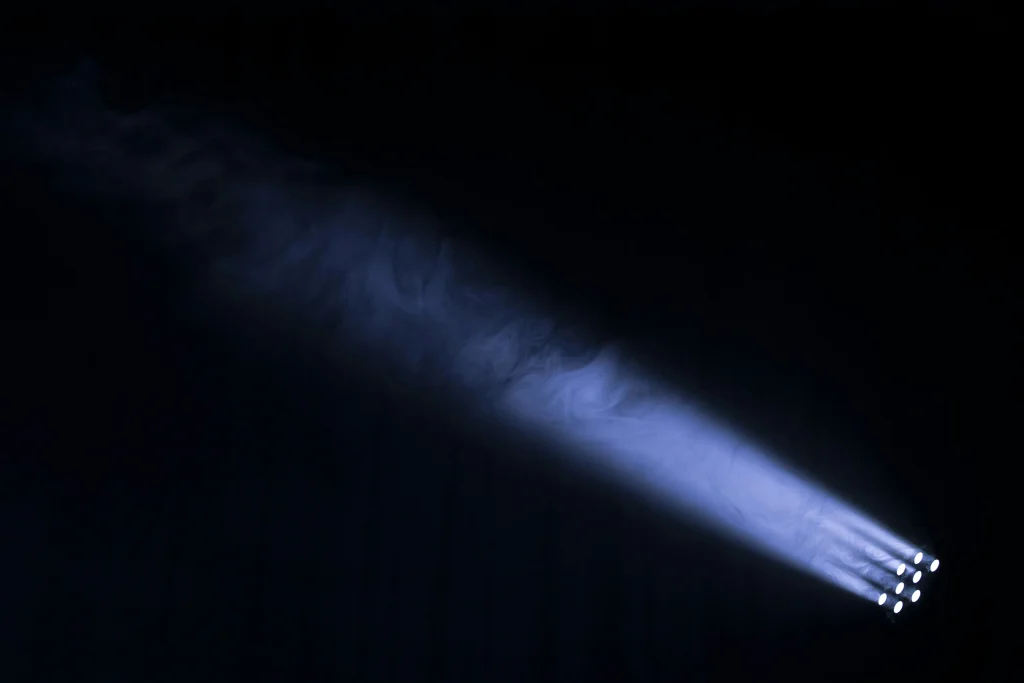 A searchlight breaking through fog.